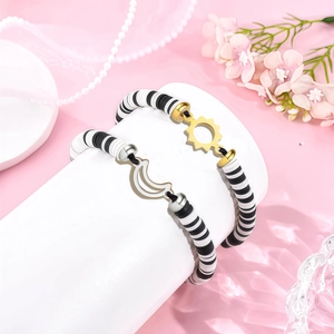 Detail of sun and moon friendship bracelets with black and white heishi clay beads