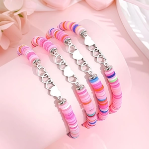 Gros plan de bracelets Heishi roses avec cœur en argent S925 et des pétales doux