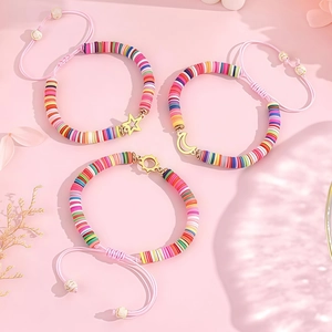 Detail of bohemian sun moon star charms on colorful heishi bead friendship bracelets