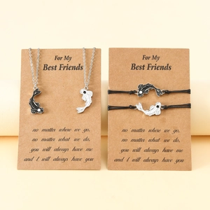 Detail of Yin Yang koi fish necklace and bracelet set on a message card gift display