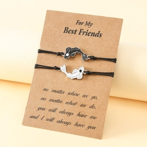 Yin Yang Koi Fish woven friendship bracelets set on a gift card for couples and friends