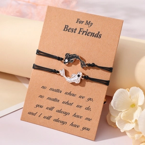Yin Yang Tai Chi fish woven friendship bracelets set on a sentimental gift card