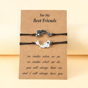 Detail of Yin Yang koi fish friendship bracelets on a gift card for best friends