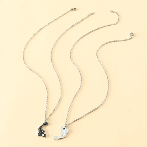 Detail of Yin Yang koi fish necklaces with scale textures and silver-toned chains