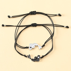 Detail of adjustable black woven bracelets with black and white yin yang koi fish charms