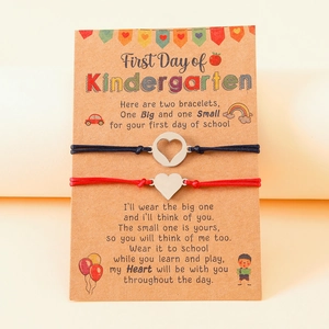 Detail of handmade mother and child wish bracelets on school theme backing card