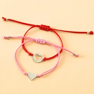 Detail of hand-woven heart bracelets with adjustable sliding knots and metal beads