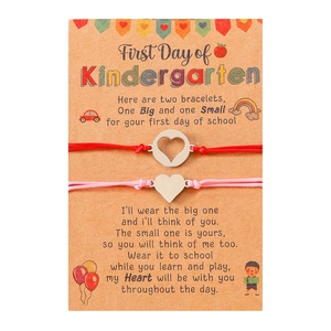 Detail of kindergarten first day mother daughter matching heart charm woven bracelets