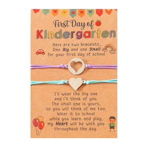 Detail of handmade woven bracelets with heart charms on kindergarten themed display card