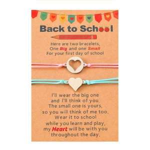 Detail of woven mother-daughter bracelets with heart charms on Back to School card