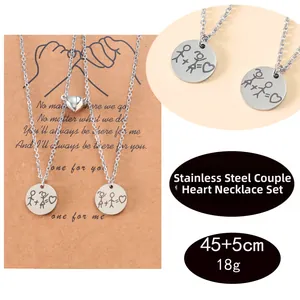 Detail of magnetic couple necklace with engraved stainless steel pendant and heart buckle