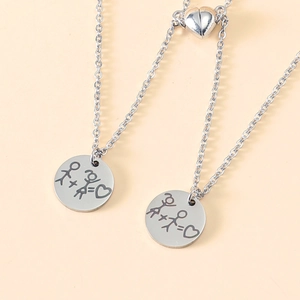 Detailed view of stainless steel couple necklaces with magnetic heart clasps and engravings