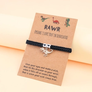 Detail of dinosaur charm bracelet with heart beads on a decorative RAWR message card