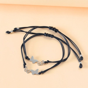 Detail view of adjustable woven butterfly bracelets with silver complementary charms