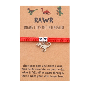 Handmade red woven dinosaur bracelet with heart beads on a RAWR theme gift card