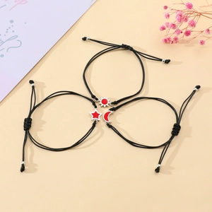 Three-piece sun moon star woven bracelets with red enamel charms on black cords