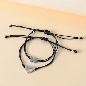 Close-up of handmade woven bracelet set with stainless steel butterfly charms