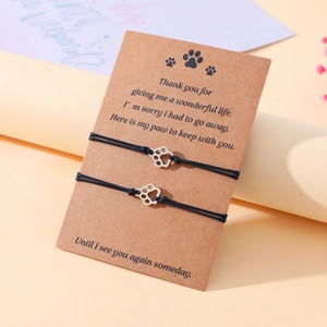 Handmade woven friendship bracelet set with cat paw print charm on sentimental card