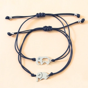 Detail of adjustable black woven rope bracelets with polished silver elephant pendants