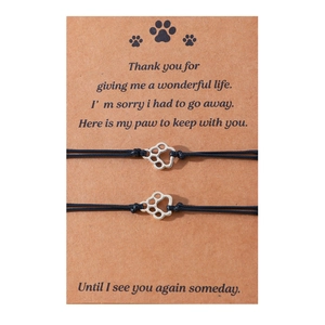 Handmade woven paw print friendship bracelet set on sentimental memorial card