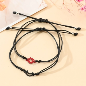 Detail of adjustable black woven bracelets with sun and moon pendants for students