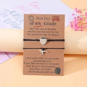 Detail of dinosaur charms on 4th Grade school bracelets with matching gift card