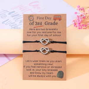 Detail of 3rd Grade back-to-school bracelets with silver heart infinity charms on gift card