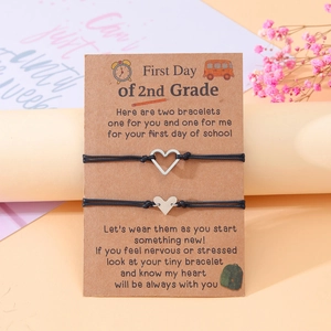 Detail of woven heart bracelets on a card for second grade back-to-school gift