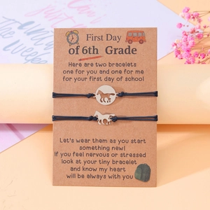 Matching woven bracelets with horse charms on 6th grade first day message card