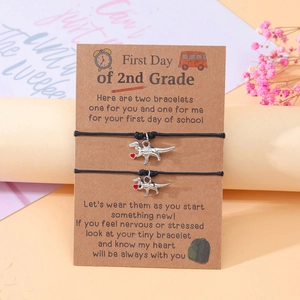 Macro detail of dinosaur charms on woven bracelets for second grade back to school gifts