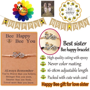 Detail showing bee and infinity charms with Sister engraving on woven friendship bracelet