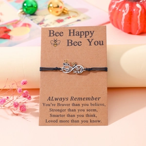 Infinity sister bracelet with bee charm on brown greeting card in gift setting