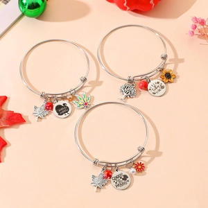 Close-up of Thanksgiving charm bracelets with turkey, maple leaf and tree of life charms