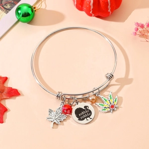 Detail of silver turkey charm bracelet with maple leaf and colorful beads for Thanksgiving
