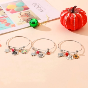 Detail of three silver stainless steel charm bracelets with Thanksgiving themed pendants
