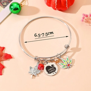 Close-up of adjustable stainless steel turkey bracelet with autumn themed charms