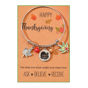 Detail of Thanksgiving charm bracelet with turkey engraving and colorful maple leaf charms