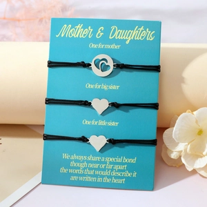 Detailansicht von drei Herz-Armbändern aus Edelstahl auf Geschenkkarte für Mutter und Töchter