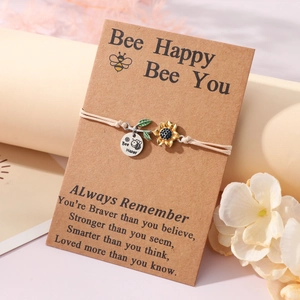 Handmade woven sunflower bracelet with Bee Happy charm and motivational gift card packaging