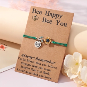 Green sunflower and bee woven bracelet on a 'Bee Happy' gift card with sunflower charms