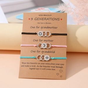 Close-up of three generation wish bracelets with sun moon star charms on display card