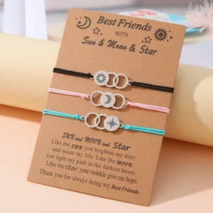 Three-piece sun moon and star friendship bracelets on a kraft paper gift card