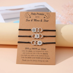Three-piece sun moon and star woven friendship bracelets on a gift card display