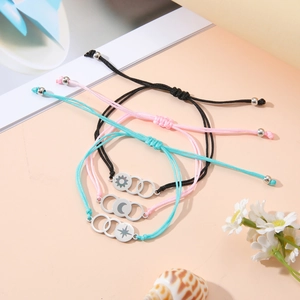 Detailed view of woven bracelets with sun, moon, and star charms in diverse colors