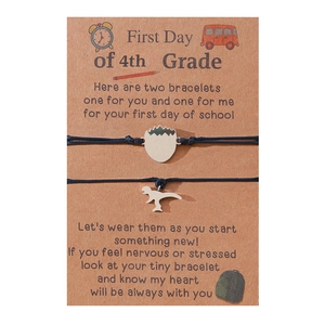 Black braided 4th grade school bracelet set with cute dinosaur charms on card