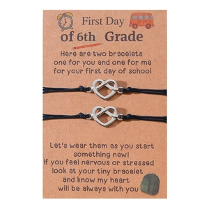 Matching 6th grade back to school bracelets with silver heart charms and black cord