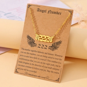 Detail view of 222 Angel Number gold necklace with butterfly wings on display card