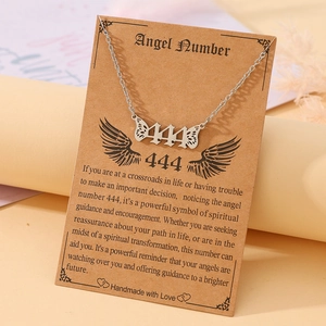 Detail of silver angel number 444 necklace with wings on a gift card display