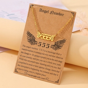 Detail of gold angel number 555 necklace with wings on vintage meaning card