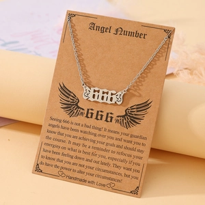 Detail of silver 666 angel number necklace with wings on an English spiritual meaning card